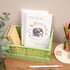 A handmade spiral-bound notebook with an elephant and floral design on the cover, titled &