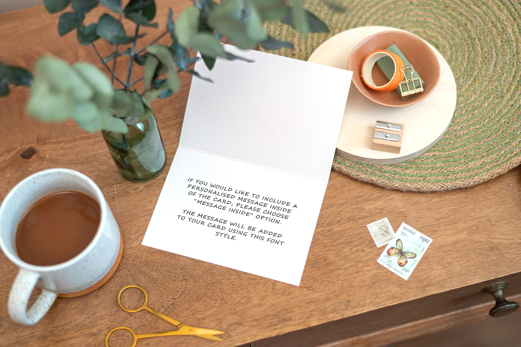 Mockup of what a message included inside of the card will look like, if chosen by the customer. The inside of the card is open, showing the writing. Card is set on a table
