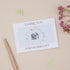 Baby Elephant surrounding by a floral ring,on a blue background .The card says thank you for the baby gift. The card is on a neutral background with stationery elements
