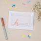 Baby shower thank you card with kangaroo illustration on a beige background with decorative items.
