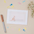 Baby shower thank you card with kangaroo illustration on a beige background with decorative items.