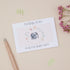 Baby Girl Floral Elephant Gift Thank You Card Set. A thank you card set with a floral design and an elephant illustration, accompanied by a Pen and floral elements displayed on a neutral background.