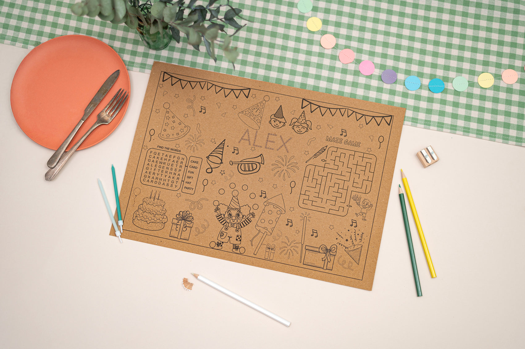 Children's activity mat with coloring and maze activities on a checkered tablecloth.