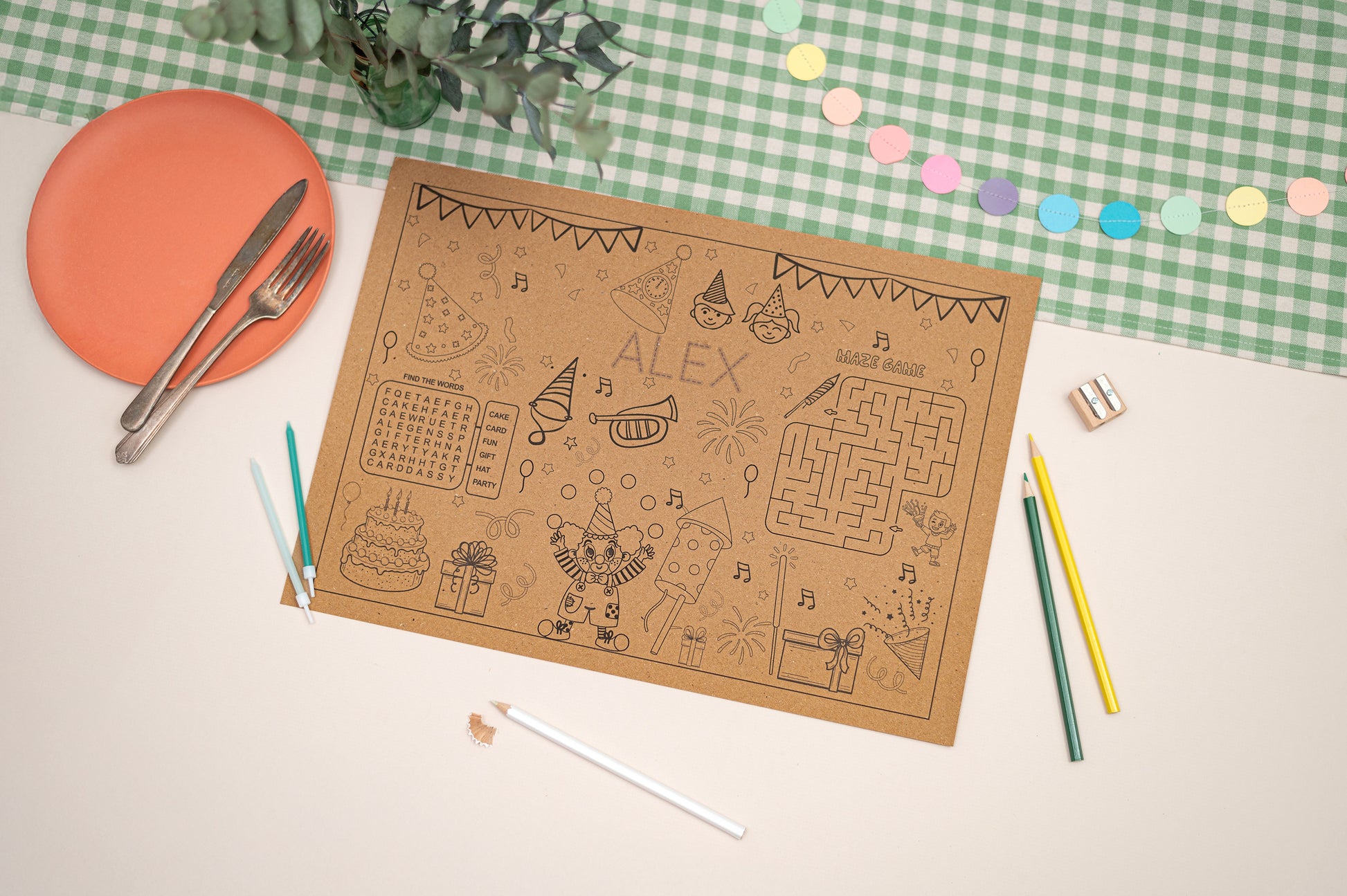 Children's activity mat with coloring and maze activities on a checkered tablecloth.
