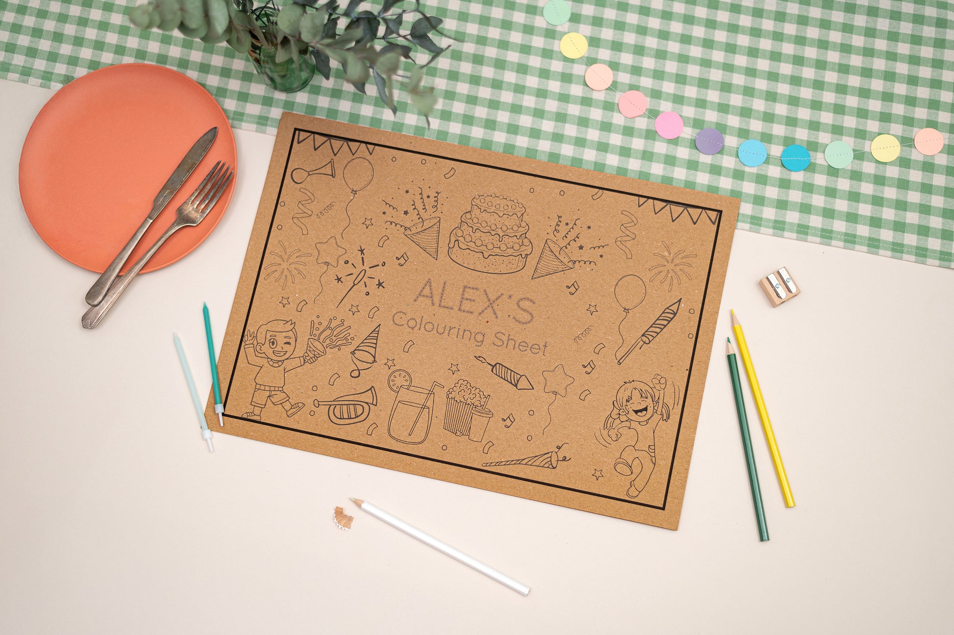 Children's colouring sheet with crayons and a plate on a checkered tablecloth