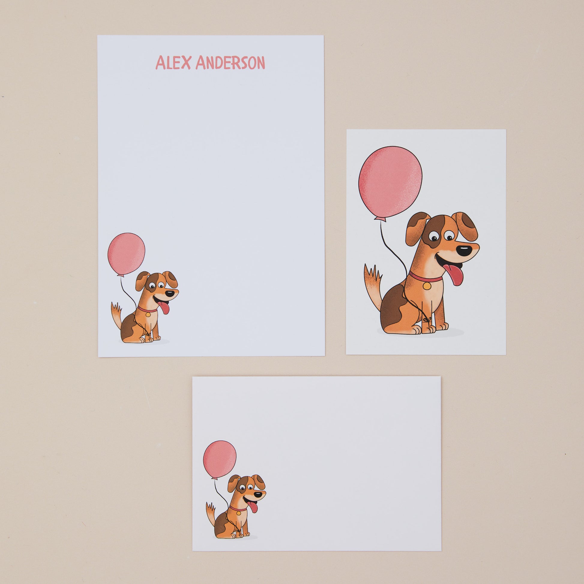 Letter writing set featuring cartoon dogs with pink balloons on a beige background