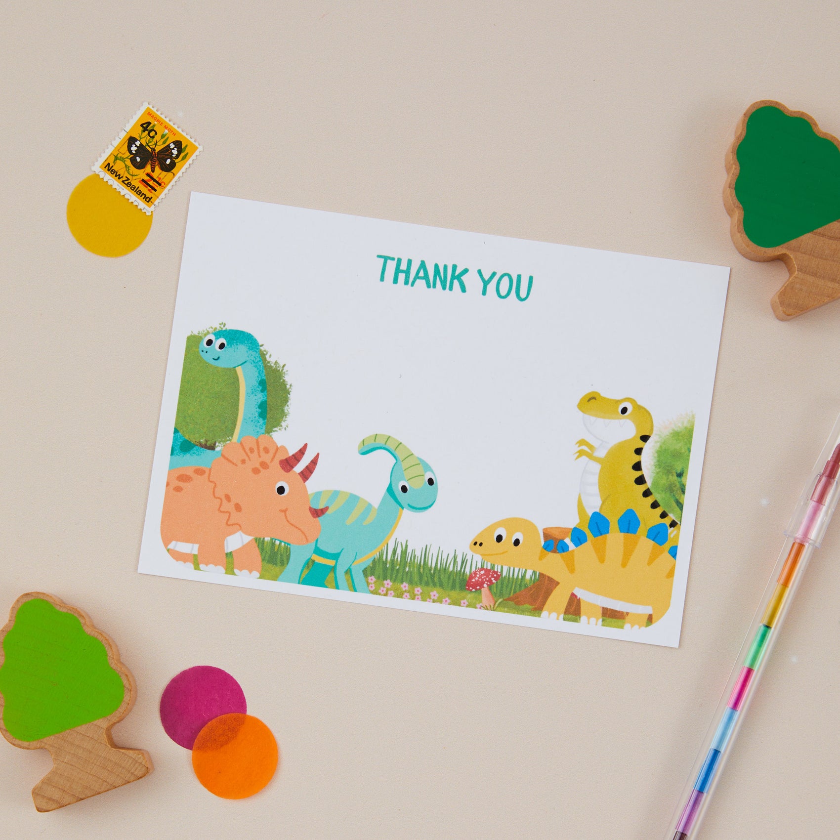 Kids Green Dinosaur Postcard Set. A set of dinosaur-themed children's  postcards with colorful illustrations of various dinosaurs, accompanied by a decorative items on a light background.