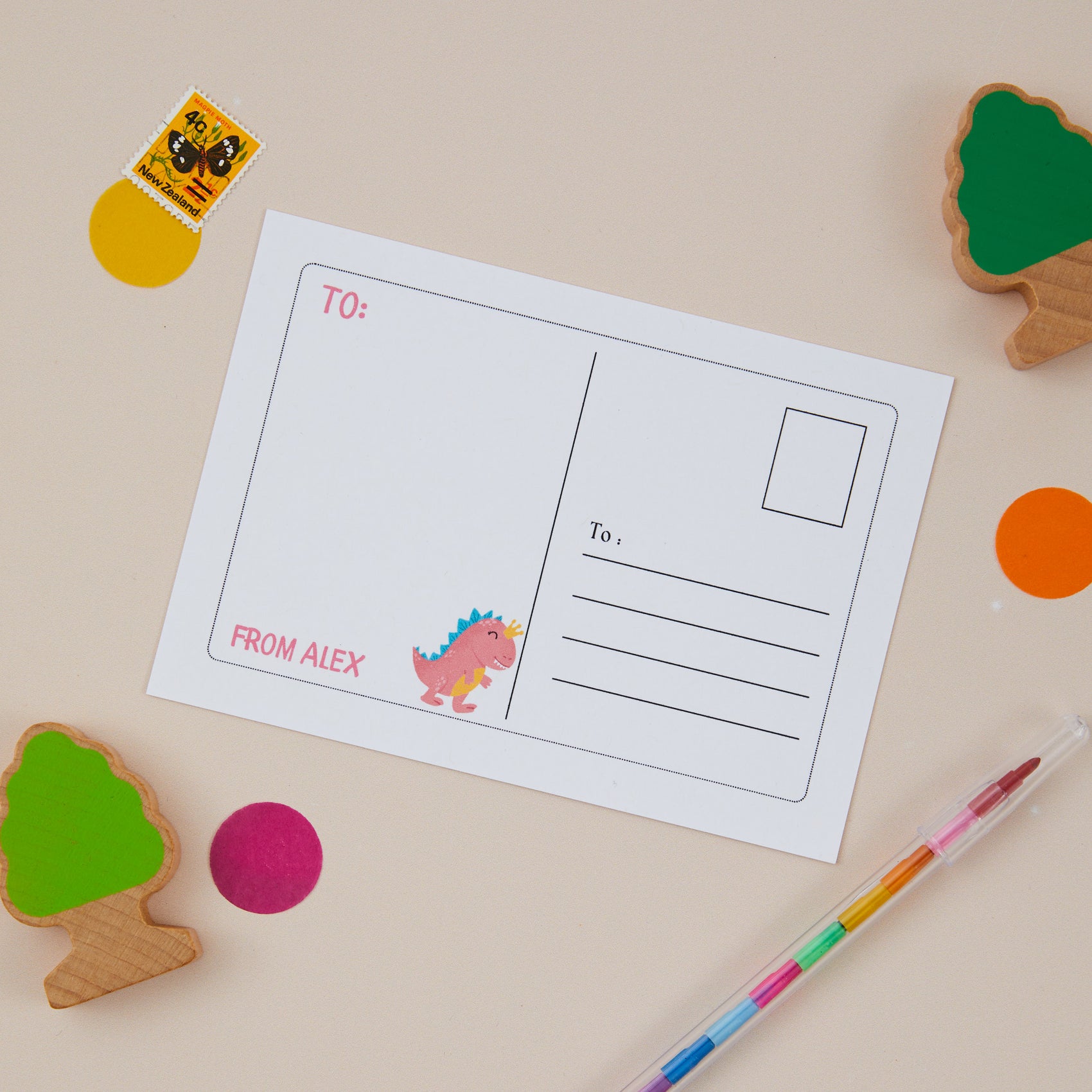Back of postcard illustration of a dinosaur on the left hand side, and on the right a postcard style back which has the area to write the address