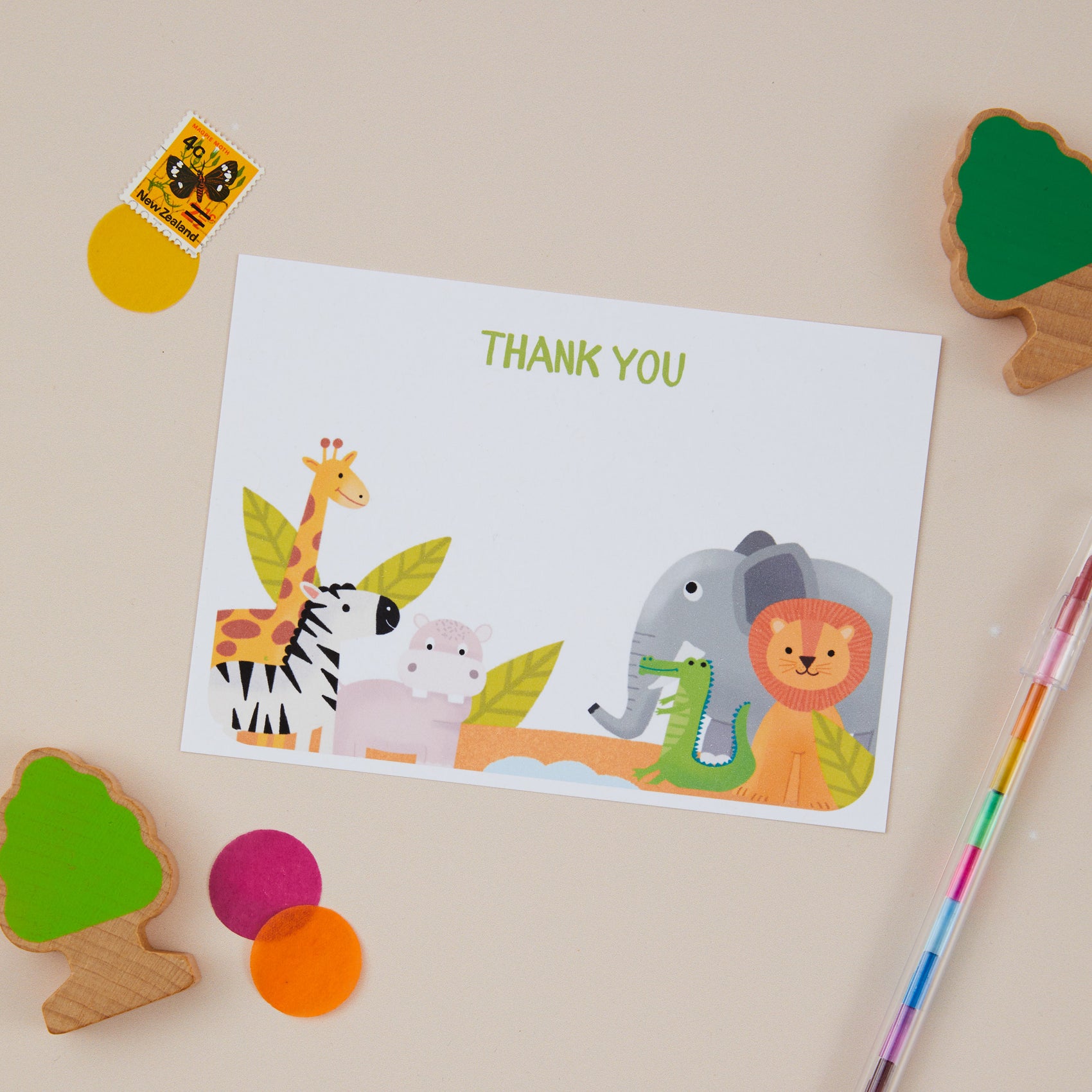 Kids Safari Postcard Set with safari theme illustrations, including a giraffe, zebra, elephant, and lion, alongside stationery and colourful children's drawing supplies.