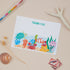 Kids Sealife Postcard Set. A set of 8 flat, sea life themed thank you postcards set with a space for a personalised message on the back, displayed on a neutral background with sealife creature motifs and stationery items.