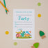 Kids birthday party baby dinosaur  invitation card with playful cartoonish dinosaurs at the bottom, surrounded by colorful confetti, dots, and two pencils on the side.