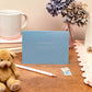 Letterpress Happy Baby Shower Card in Blue with silver font which says happy baby shower, can't wait to meet the new arrival