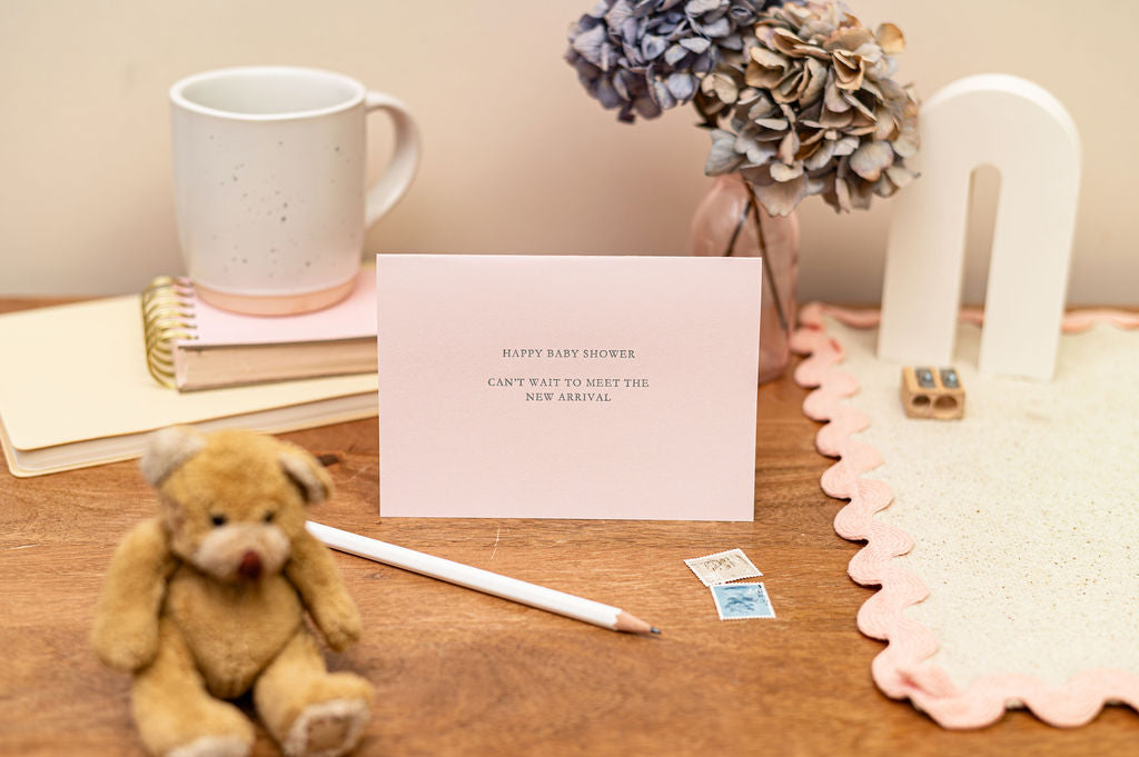 Letterpress Happy Baby Shower Card in Pink with silver font which says happy baby shower, can't wait to meet the new arrival