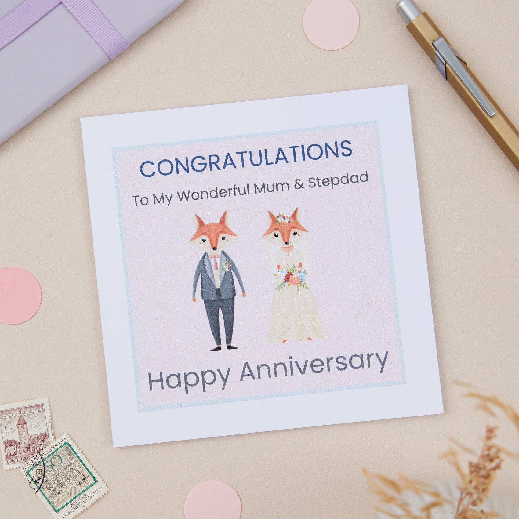 A Mum And Stepdad Happy Anniversary Card with an illustration of a dressed-up fox and a dressed-upMrs. Fox, with a 'Congratulations Happy Anniversary' message.