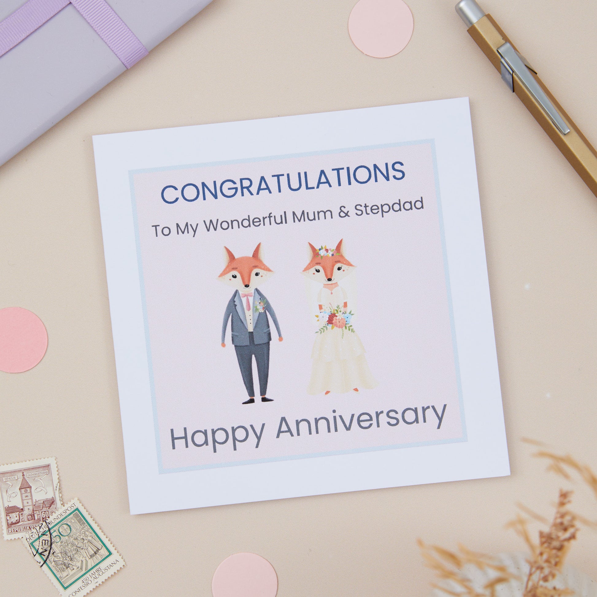 A Mum And Stepdad Happy Anniversary Card with an illustration of a dressed-up fox and a dressed-upMrs. Fox, with a 'Congratulations Happy Anniversary' message.
