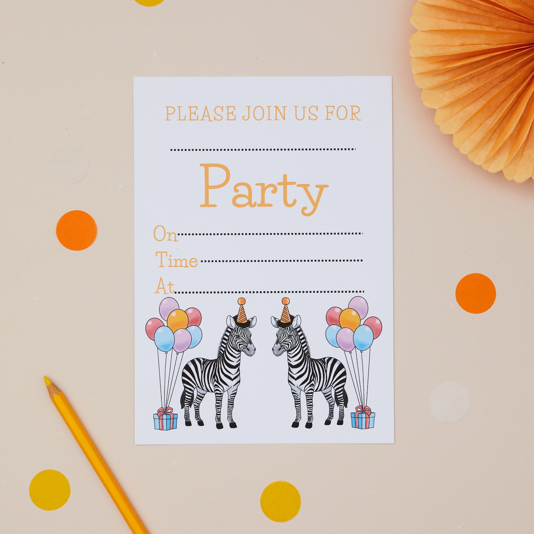 Party Unicorns Childrens ready to write birthday invites. Two Zebras wearing party hats. There are balloons and presents. The Invitations is on a beige background with orange confetti, pencils and a paper fan