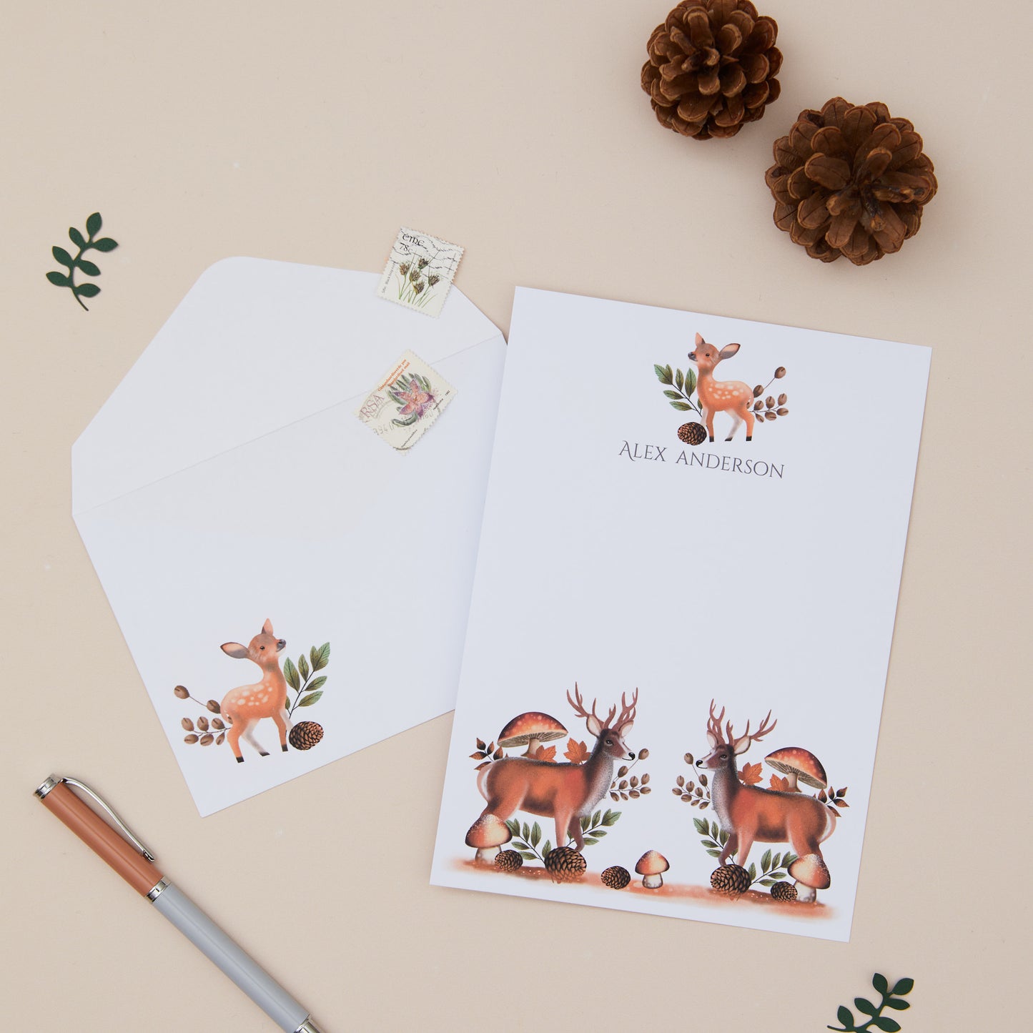 Personalised Deer Letter Writing Set with matching envelopes set against a beige background with woodland element decorations and stationery