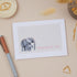A sympathy greeting card with an illustration of an elephant and its calf, with the text &