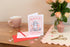 A greeting card with a cartoon image of a cat and the text &