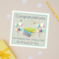 Theory Test Congratulations card with balloons and books on a beige background. The Card has the text "Congratulations on passing your theory test - so proud of you"