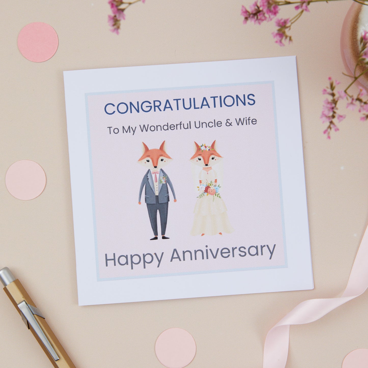 A Uncle Wedding Anniversary Card with an illustration of a fox couple dressed in bridal attire, with a 'Congratulations' message to uncle and wife on their wedding anniversary.