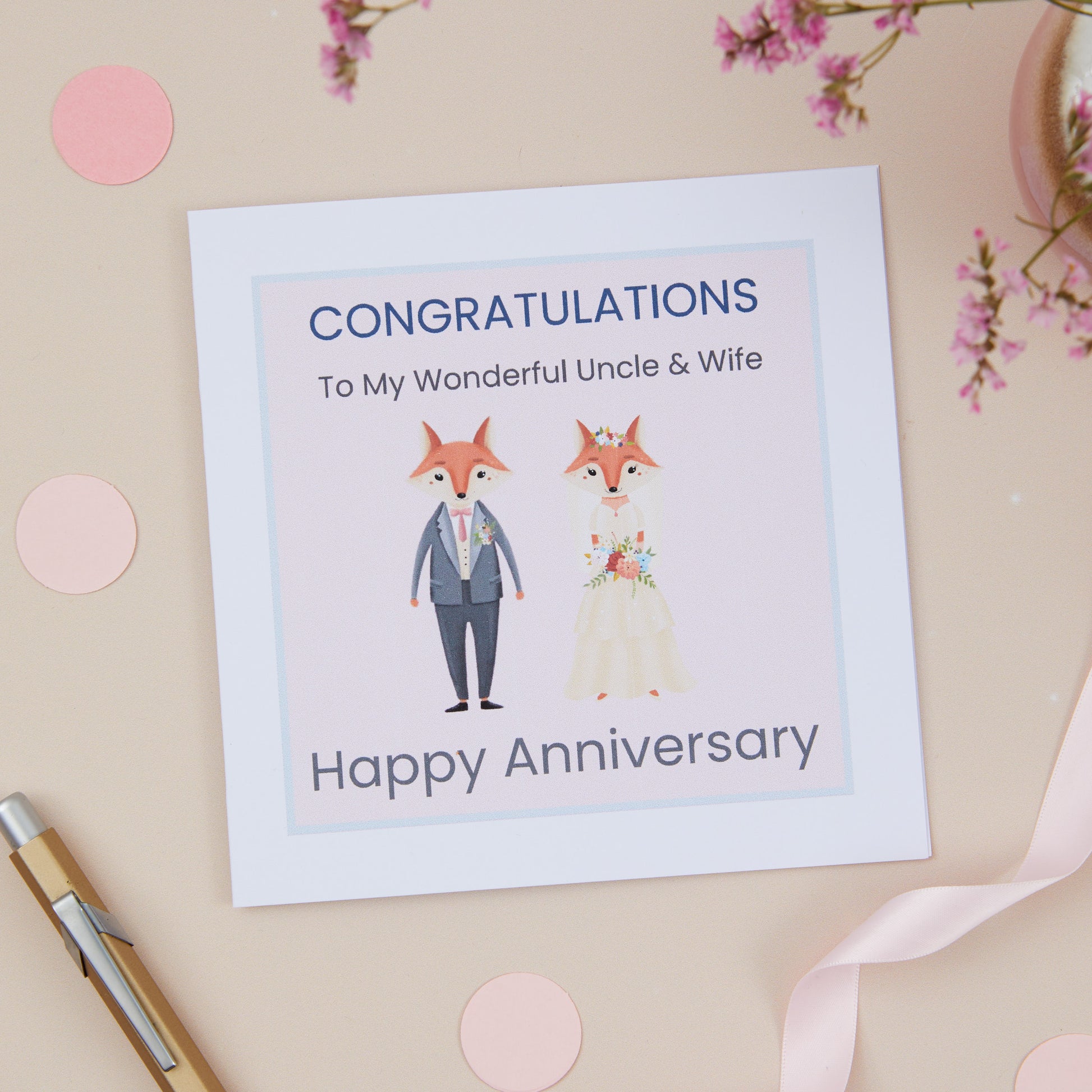 A Uncle Wedding Anniversary Card with an illustration of a fox couple dressed in bridal attire, with a 'Congratulations' message to uncle and wife on their wedding anniversary.