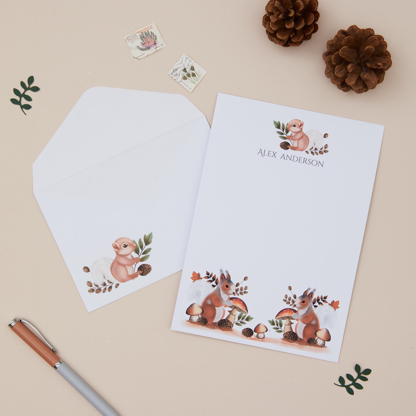 Woodland Squirrel Letter Writing Set With Envelopes, pen, and decorative items on a beige background