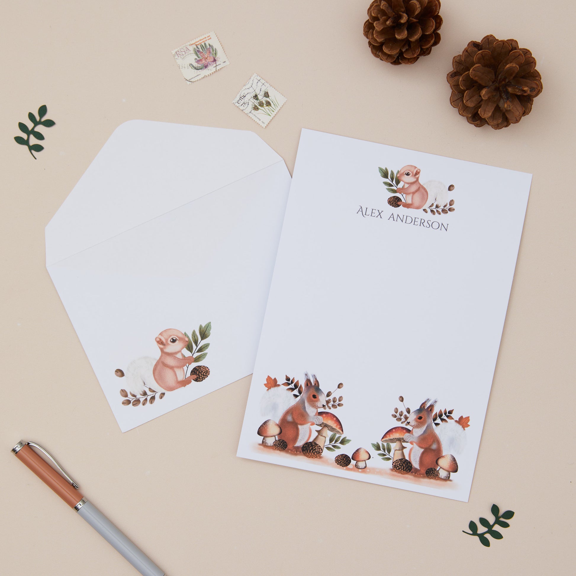 Woodland Squirrel Letter Writing Set With Envelopes, pen, and decorative items on a beige background