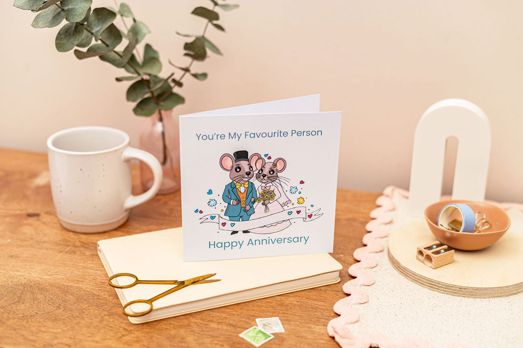 Wedding Anniversary Card - You're my Favourite person, featuring mr and mrs mouse. Card is set on a desk with stationery items around it.